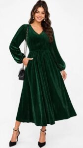 Woman wearing a long-sleeve burgundy velvet midi dress for a winter wedding